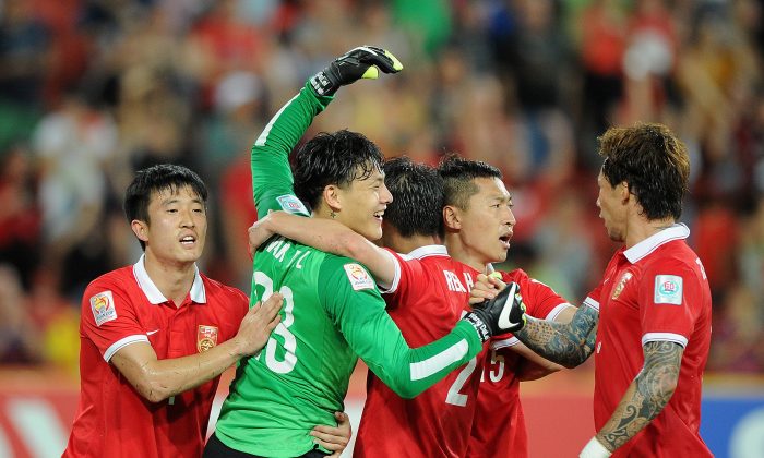 Chinese soccer players celebrate winning the 2015 Asian Cup match between Saudi Arabia and China PR at Suncorp Stadium in Brisbane, Australia, on Jan. 10, 2015. (Matt Roberts/Getty Images)