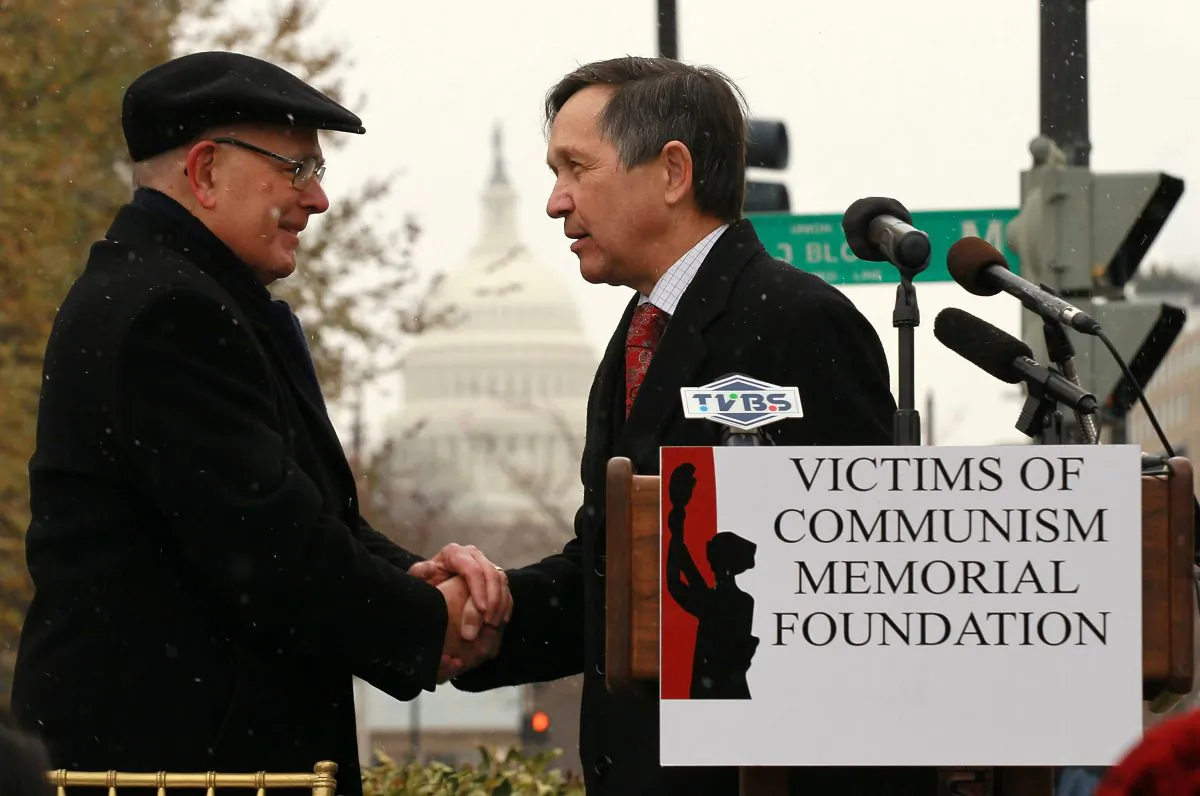 Chairman of Victims of Communism Memorial Foundation Lee Edwards (L) shakes hands with U.S. Rep. Dennis Kucinich (D-OH) (R) during a rally for jailed Chinese dissident and Nobel Prize laureate Liu Xiaobo in Washington, D.C., on Dec. 10, 2010. Liu was represented with an empty chair when he was awarded with the Nobel Peace Prize during the presentation ceremony in Oslo, Norway. (Alex Wong/Getty Images)