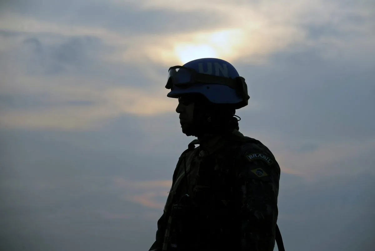 A Brazilian soldier with the MINUSTAH force stands during a patrol at a shantytown in Port-au-Prince, Haite, on March 2, 2013. (Vanderlei Almeida/AFP/Getty Images)