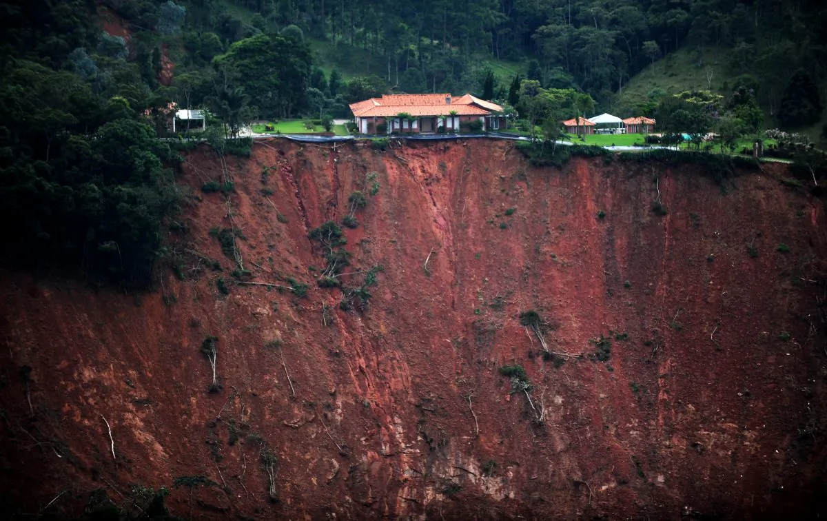 Aerial view of a house at risk following landslides in the locality of Poco Fundo, near Petropolis, in the state of Rio de Janeiro, Brazil, on Jan. 18. A week after Taina and Angel Urrutia, and baby Mila, survived the deadliest mudslides in Brazil's history. On Tuesday the country was still counting the dead and struggling to bring aid to survivors. (Vanderlei Almeida/AFP/Getty Images)