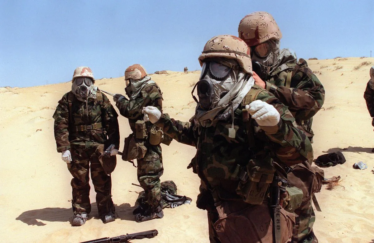 U.S. soldiers from the 4th Regiment of Marines help each other to dress full anti-chemical equipments on Aug. 23, 1990, during a training operation in the Saudi desert a few days after the Iraqi army entered the Kuwait. (Gerard Fouet/AFP/Getty Images)
