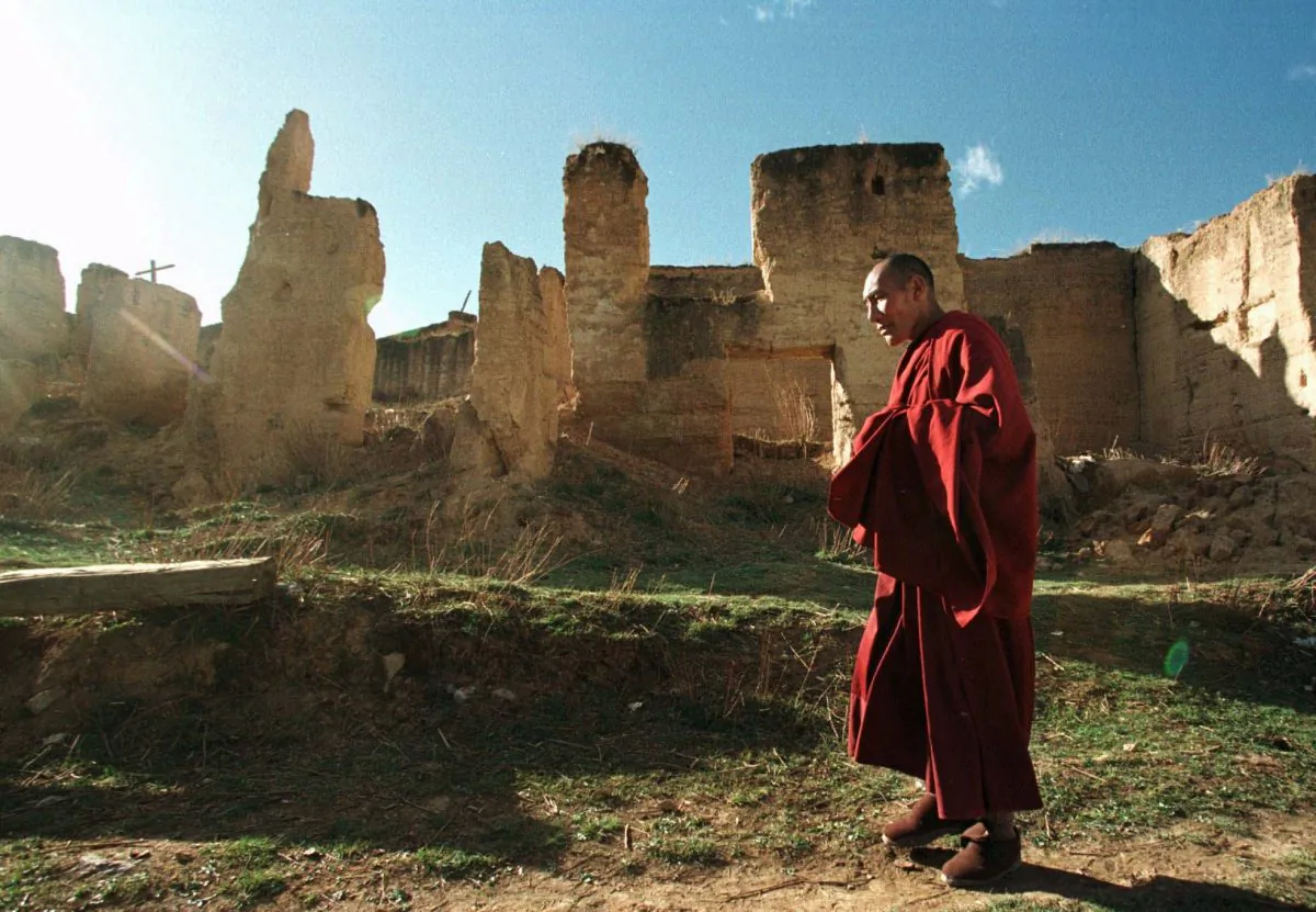 A Tibetan monk walks past ruins at the Gedan Songzan Monastery at Zhongdian, in China's Yunnan Province, on April 23, 1998. Much of the 300 year-old monastery was destroyed by radical communists during China's Cultural Revolution. (Greg Baker/AP Photo)
