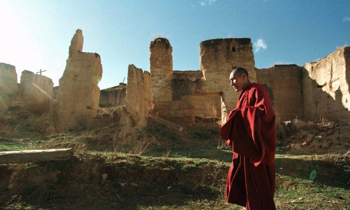 A Tibetan monk walks past ruins at the Gedan Songzan Monastery at Zhongdian, in China's Yunnan Province, on April 23, 1998. Much of the 300 year-old monastery was destroyed by radical communists during China's Cultural Revolution. (Greg Baker/AP Photo)