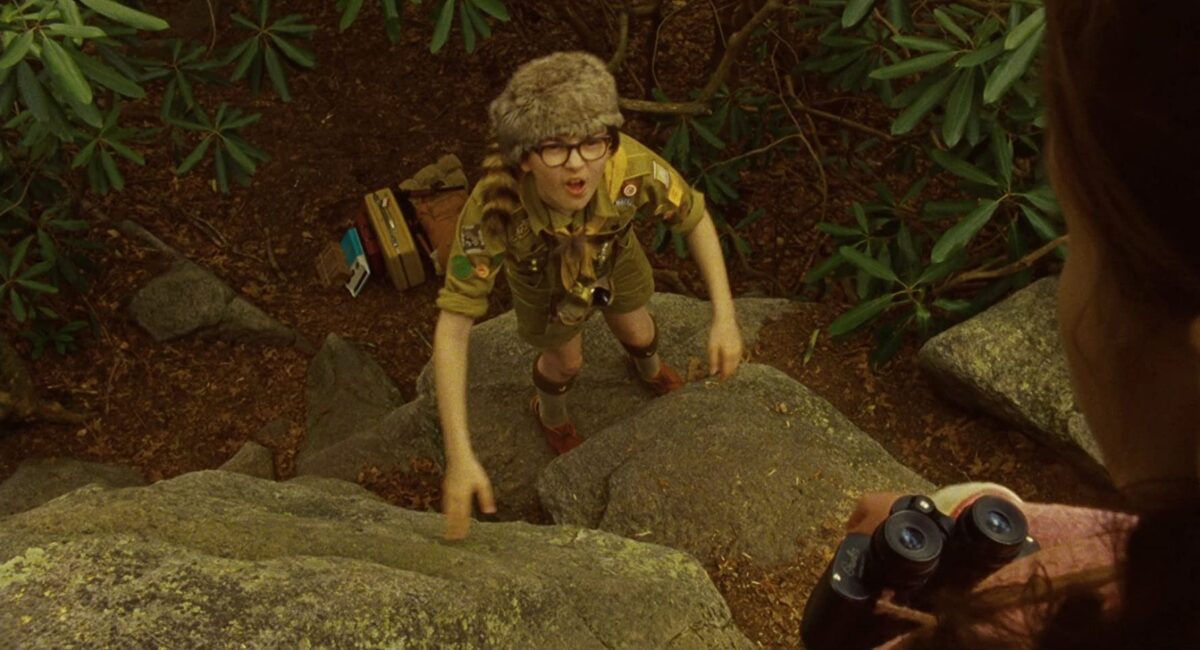 boy climbs cliff in "Moonrise Kingdom"