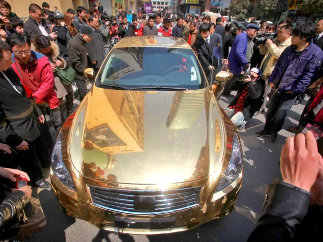 A gold-plated Infiniti luxury sports car outside a jewelry store in Nanjing, in East China’s Jiangsu Province, March 31, 2011. (STR/AFP/Getty Images)
