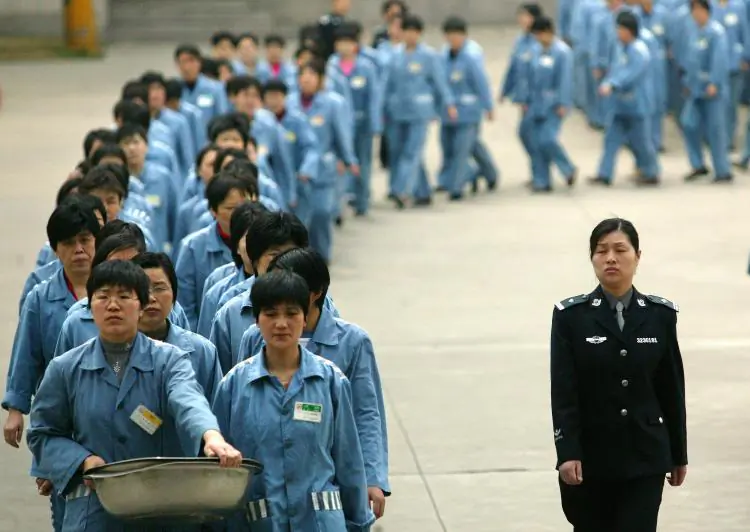 Prisoners walk beside a police escort during a prison open day in Nanjing, 2005.(STR/AFP/Getty Images)