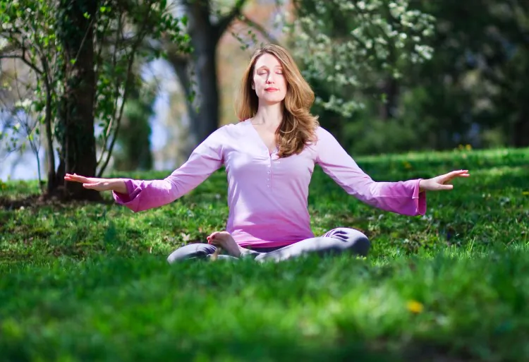 A women performs the Falun Gong sitting meditation. Researchers found that meditation and positive thinking can produce long-term brain changes and development of positive traits. (Jeff Nenarella/The Epoch Times)