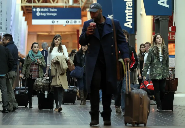 A man walks through Washington, D.C.’s Union Station on Nov. 21, 2012 with a four-wheeled spinner suitcase. In the background are numerous travelers pulling two-wheeled suitcases. (Alex Wong/Getty Images)