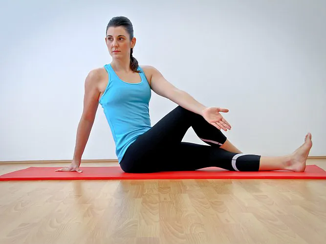 The spine-rotation stretch promotes spinal mobility. (Jocelyn Bong)