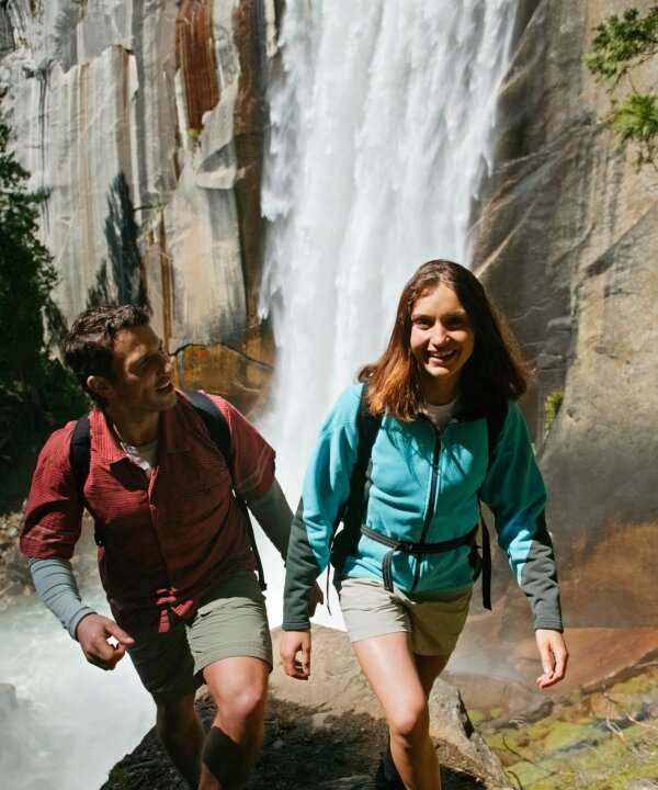 Hikers pass by a waterfall on their trail. Waterfalls command our attention, in part because we hear them much earlier than we see them. (Jupiterimages)