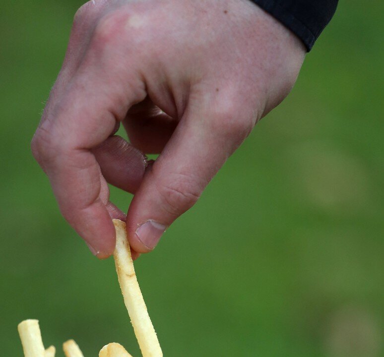Sneaking a bite here, a bit there can easily lead to eating hundreds of extra calories. (Getty Images)