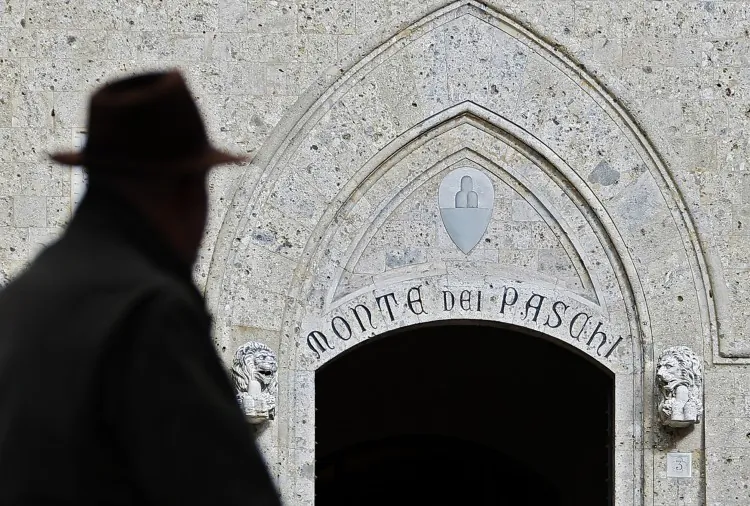 A man walks past the headquarters of the Banca Monte dei Paschi di Siena, the world's oldest bank, on Jan. 25. has to secure a €5 billion capital to survive. (Fabio Muzzi/AFP/Getty Images)