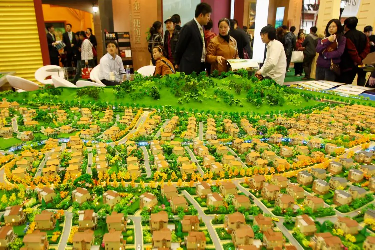 Sales people introduce properties to potential buyers at the 2010 Beijing Spring Real Estate Trade Fair on April 10, 2010 in Beijing, China. The Chinese economy is endangered by capital flight, fake FDI and corrupt real estate speculation, experts say. (Feng Li/Getty Images)