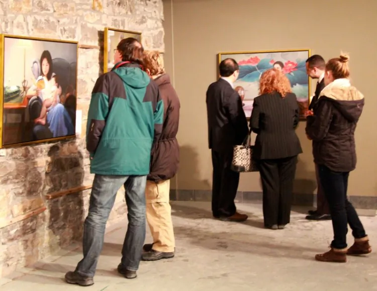 Visitors view the artworks on opening night (Pam McLennan/ Epoch Times)