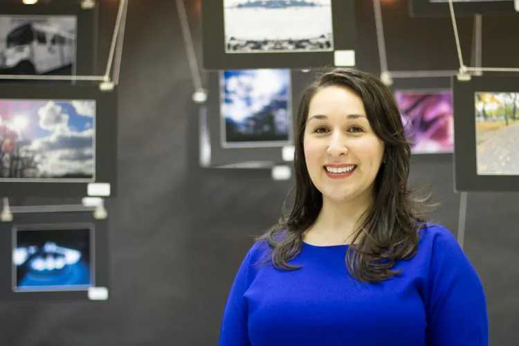 Jennifer Martinez, humanities teacher at CUNY Prep school, stands in front of her students' photography display in her classroom in the Bronx, New York City, March 20,2013. (Benjamin Chasteen/The Epoch Times) 