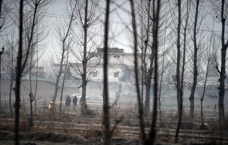 Pakistani policemen stand guard beside the compound of slain Al-Qaeda chief Osama bin Laden in northwestern Abbottabad town on Feb. 26, 2012. (Aamir Qureshi/AFP/Getty Images)
