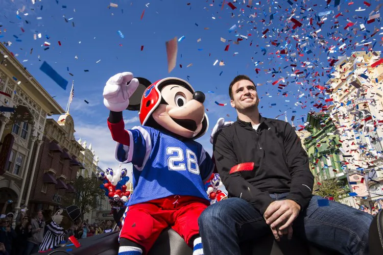 Joe Flacco rides Feb. 4, 2013 with Mickey Mouse in a parade through the Magic Kingdom at Walt Disney World Resort in Lake Buena Vista, Fla. (Matt Stroshane/Disney Parks via Getty Images)
