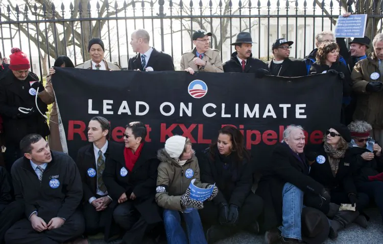 American social activist Julian Bond (second left) and others protest against the Keystone XL pipeline on Feb. 13, 2013, in Washington, D.C. A $30,000 ad in the New York Times touting the benefits of the Keystone XL pipeline was taken out by the Alberta government in a bid to influence public opinion in favour of the project. U.S. president Barack Obama is expected to decide whether to approve the pipeline in the coming months. (Photo by Leigh Vogel/Getty Images)