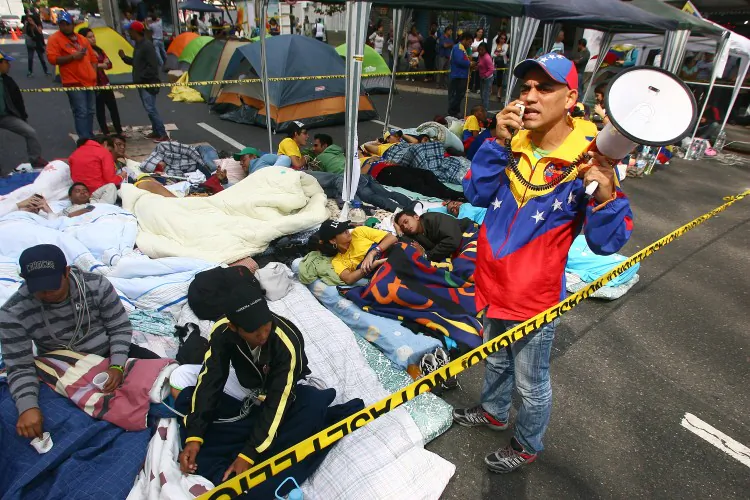 Students camp in protest across an avenue in Caracas on Feb. 28, 2013. The students believe that the government is not saying the truth about Venezuelan President Hugo Chavez's health. (Geraldo Caso/AFP/Getty Images)