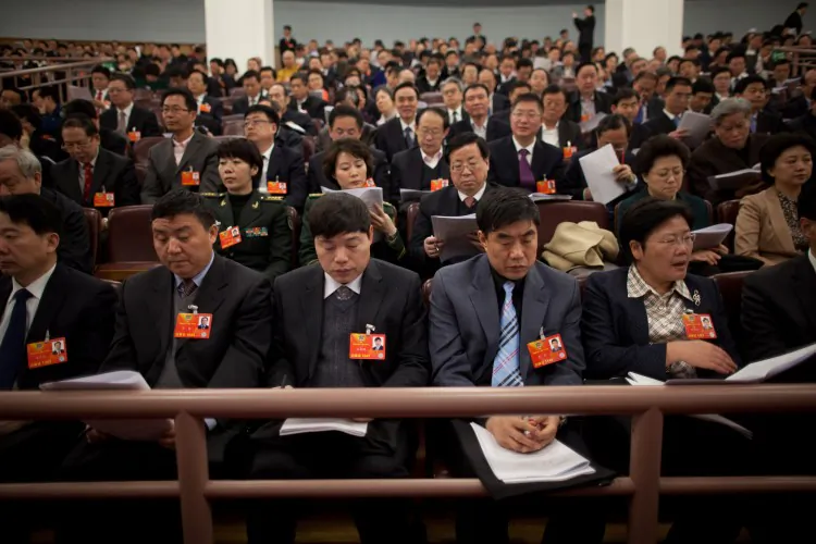 Delegates sit inside the Great Hall of the People during the opening session of the National People's Congress (NPC) in Beijing on March 5. Thousands of delegates will gather in Beijing to affix a rubber stamp to the last phase of the communist leadership changeover, among other policy items. (Ed Jones/AFP/Getty Images)