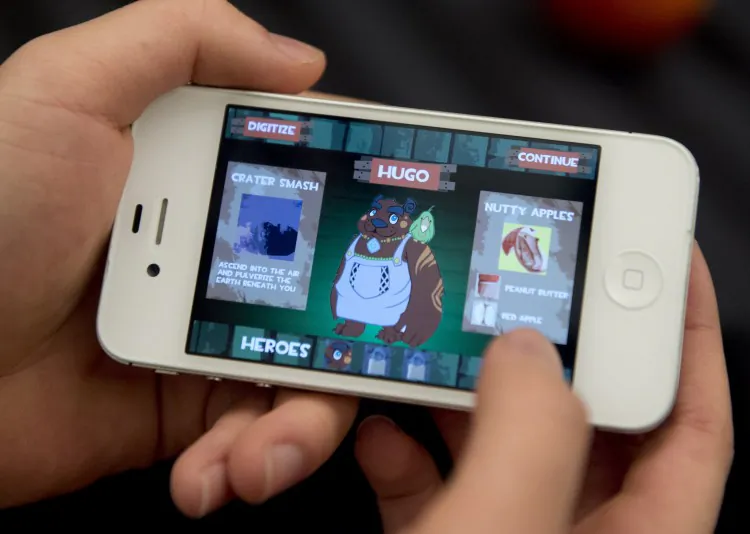 Smartphone user Dennis Ai is seen playing a game on his iPhone 5. (Saul Loeb/AFP/Getty Images)