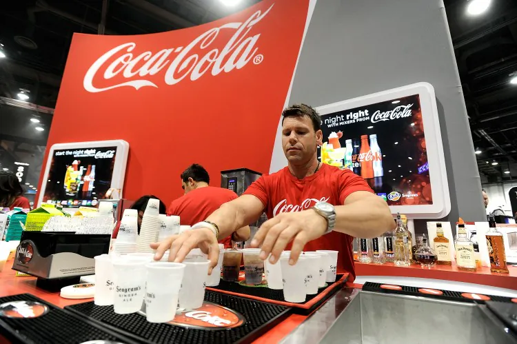 People sample beverages at the Coca Cola booth during the 28th annual Nightclub & Bar Convention and Trade Show at the Las Vegas Convention Center on March 20th, 2013. (David Becker/Getty Images for Nightclub & Bar Media Group)