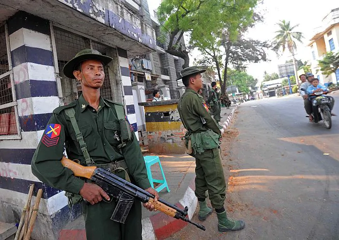 Soldiers stand guard in riot-hit Meiktila, central Burma on March 23, 2013. Troops patrolled the streets after Buddhist-Muslim unrest tore through the area leaving at least 20 dead and spurring the government to declare emergency rule. (Soe Than WIN/AFP/Getty Images)