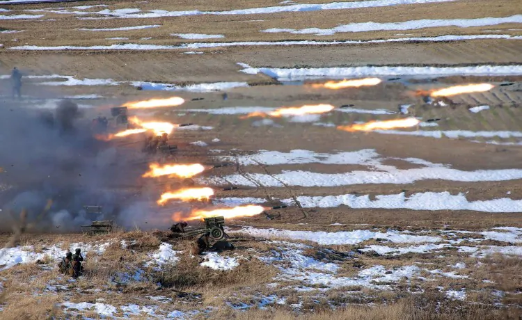 This picture released by North Korea's official Korean Central News Agency on March 26, 2013 and taken on March 25, 2013 shows North Korean female artilleries firing rockets. (KCNA VIA KNS/AFP/Getty Images)
