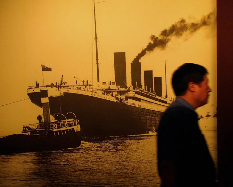 A visitor walks past a big portrait of the Titanic at the Titanic Experience and Priceless Artifact Exhibition in Shanghai in August 2004. (Liu Jin/AFP/Getty Images)