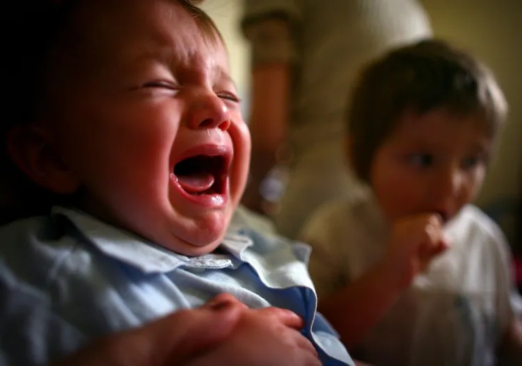 A young boy reacts to receiving a immunization jab at a health center in September 3, 2007 in Glasgow, Scotland. (Jeff J Mitchell/Getty Images)