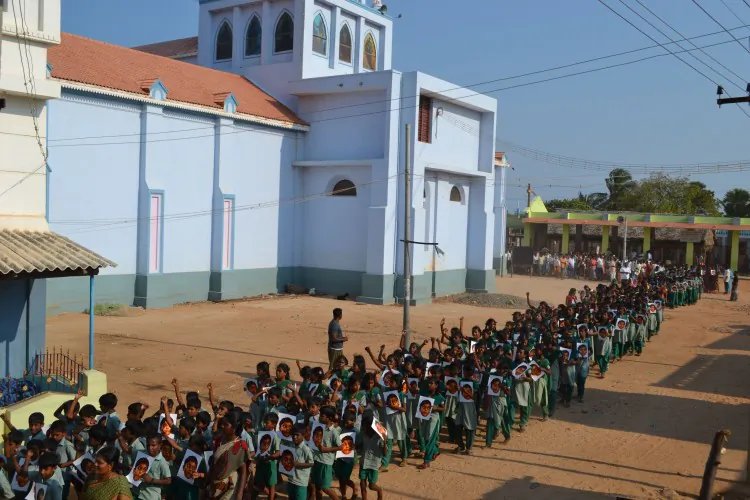 School children rally against the alleged human rights violations against Tamilians, during the Sri Lankan civil war at Kuthenkazhi village in southern Tamil Nadu, on March 21, 2013. The children are seen holding the portrait of the 12 year-old-son of Sri Lankan Tamil leader Velupillai Prabhakaran, allegedly murdered by the Sri Lankan army. (Pushparayan Victoria)