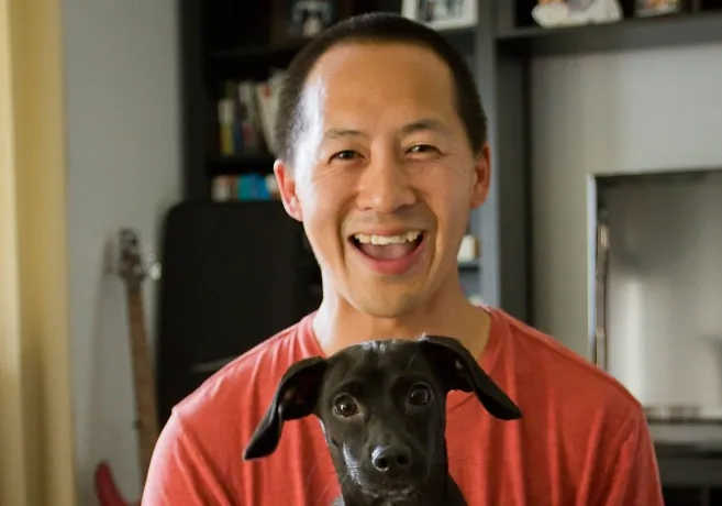 Ferdie Yau, owner of Sits and Wiggles dog training in New York, sits with Mori, a 7 month old dachshund-chihuahua mix. (Sean Kim/Sits and Wiggles)