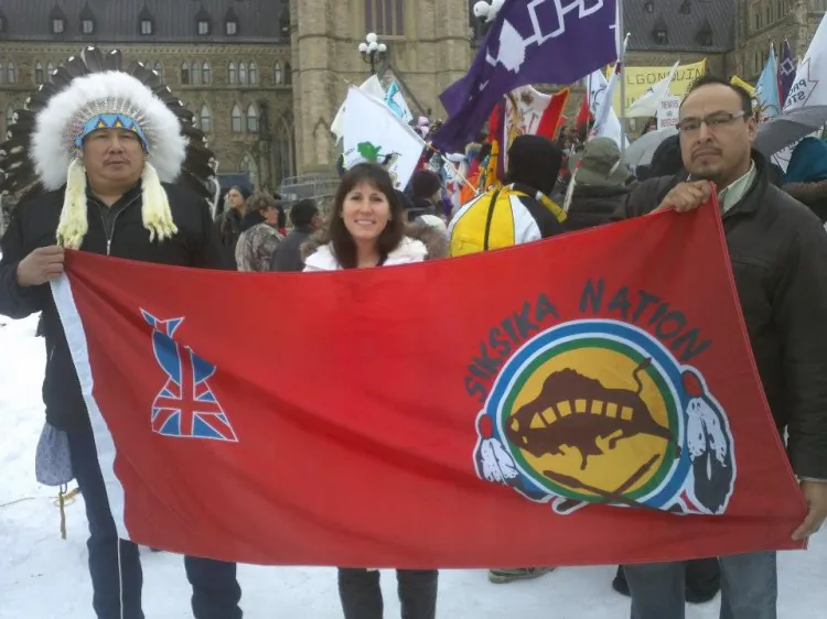 Two members of the Siksika Nation from southern Alberta and a non-aboriginal supporter protest in Ottawa as part of the Idle No More movement. Negative perceptions about aboriginals have increased, sparking a need for national dialogue, the Canadian Race Relations Foundation says. (Michelle Caron/Wikipedia)
