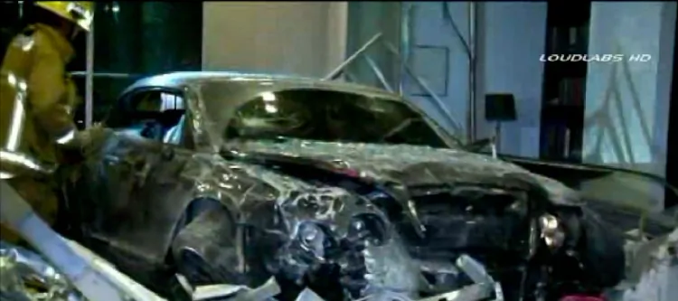 A screenshot of a KTLA broadcast showing Jordan Hill's totaled Bentley in the lobby of a luxury condominium building in Los Angeles. (Screenshot via The Epoch Times)