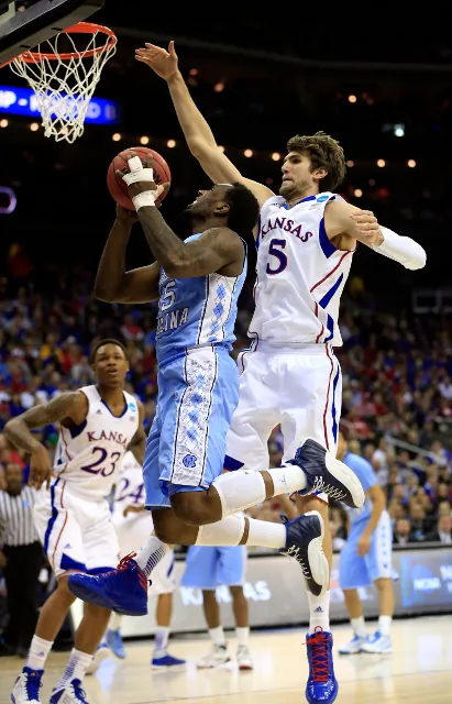 Kansas center Jeff Withey (R) had five blocks Sunday against North Carolina and is just six blocks away from tying Tim Duncan's all-time tournament record of 50. (Jamie Squire/Getty Images)