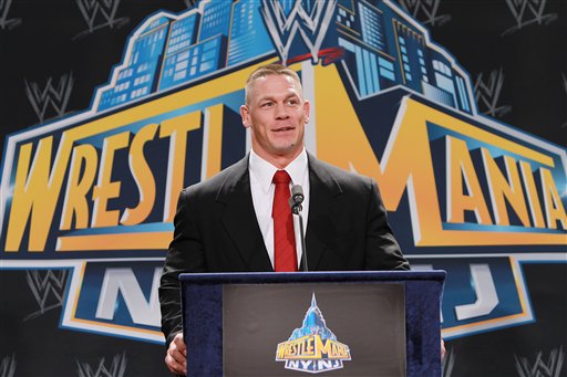In this Thursday, Feb. 16, 2012 photo, World Wrestling Entertainment personality John Cena speaks at a news conference in East Rutherford, N.J., to announce that MetLife Stadium will host WrestleMania XXIX on April 7, 2013. WWE is joining with New York Mayor Michael Bloomberg, New Jersey Gov. Chris Christie, Hollywood celebrities and professional athletes to launch Superstars for Sandy Relief. Fans can bid on hundreds of items in an online auction, including attending a NASCAR race with Cena, meeting Tyra Banks on the set of “America's Next Top Model,” or pitching entrepreneurial ideas to Mark Cuban. The auction begins Monday, March 25, 2013, and closes April 9 on charitybuzz.com. (AP Photo/StarPix, Dave Allocca)