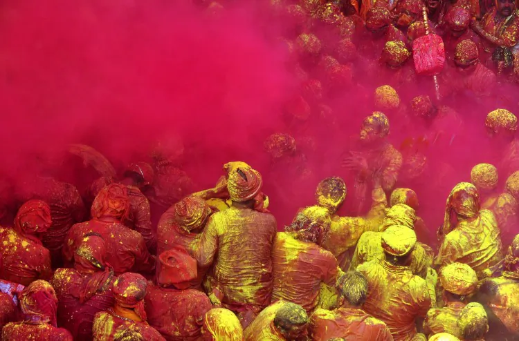 Indians play with colored powder, celebrating theregional Lathmar Holi festival in Barsana, on March 21, 2013. Lathmar Holi is a local celebration, but it takes place well before the national Holi day on March 27. (Sanjay Kanojia/AFP/Getty Images)