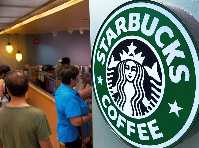 Customers line up for coffee at a Starbucks inside Dulles Airport near Washington, August 2011. (Paul J. Richards/AFP/Getty Images)