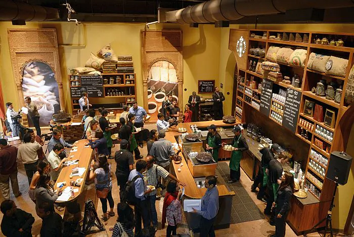 A worker pours coffee at the newly inaugurated Starbucks outlet in New Delhi on Feb. 6, 2013. The Seattle-based firm entered the vast Indian market with its first store in Mumbai in October 2012, making an initial $78 million investment and aiming for 50 cafes by the end of 2013. (Sajjad Hussain/AFP/Getty Images)