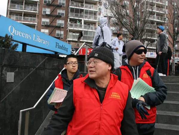 Zhu Lichuang, an anti-Falun Gong activist, helped to hand out literature attacking the spiritual practice in Flushing on March 30. (The Epoch Times)