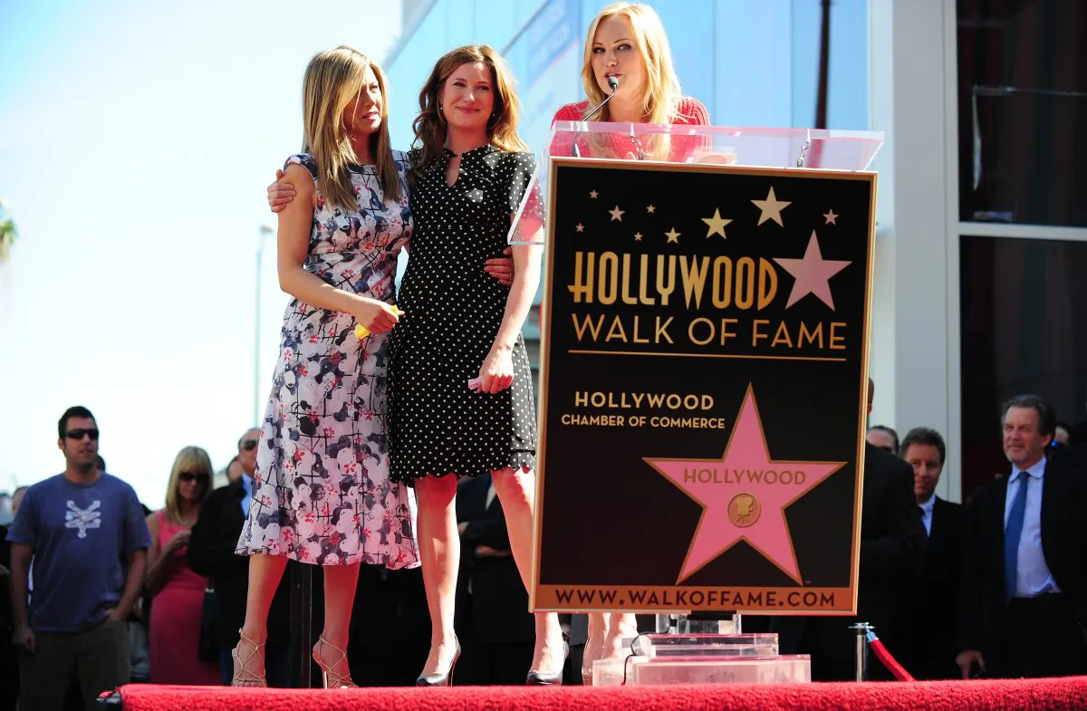 Malin Ackerman (R) speaks from the podium as Jennifer Aniston (L) and Kathryn Hahn (C) listen during a ceremony ahead of the unveiling of Aniston's Star on Hollywood's Walk of Fame on February 22, 2012 in Hollywood, California. (Frederic J. Brown/AFP/Getty Images)