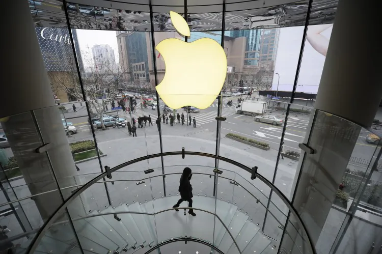 A customer walks under an Apple logo at an Apple store in Shanghai on Feb. 22, 2012. An Apple computer with filtering software installed on it was recently shipped from Shanghai to a customer in New York. (PETER PARKS/AFP/Getty Images)