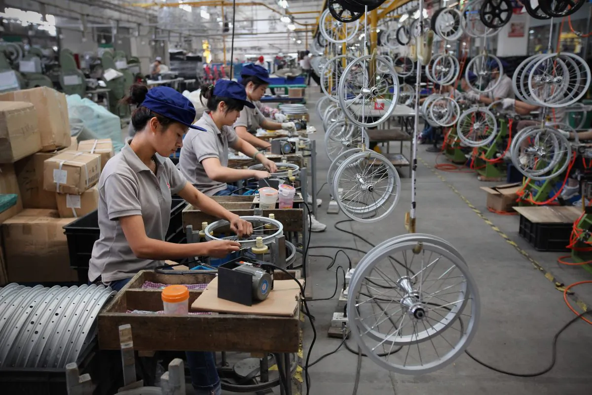 An undated photo shows workers assembling children's bicycle wheels at a factory in China. (Feng Li/Getty Images) 