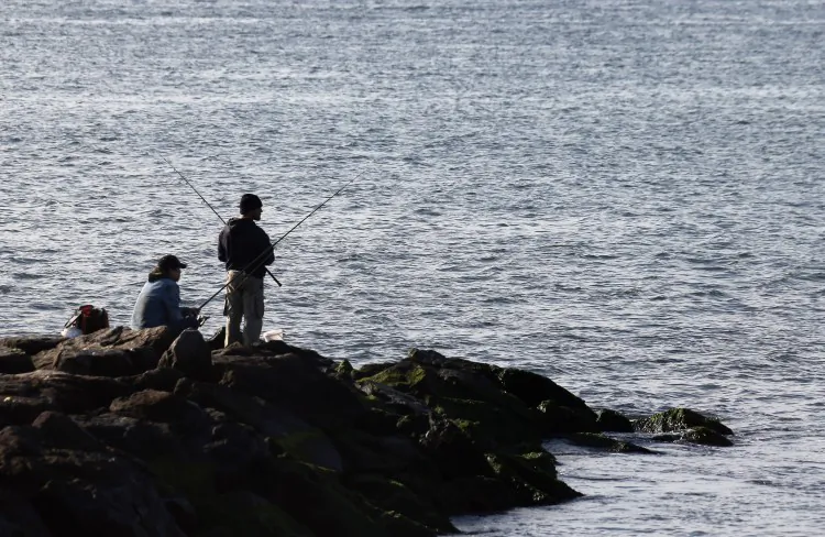 People fish in the ocean in Long Beach, New York in Oct. 2012. Fishing season is opening for 2013 as of April 1. (Bruce Bennett/Getty Images)