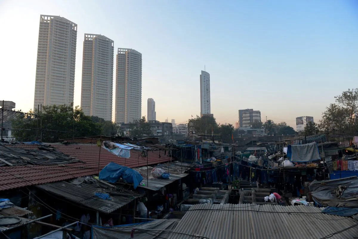In this file photo taken on Dec. 13, 2012, luxury residential highrises loom over an open air laundry facility known as the Mahalaxmi Dhobi Ghat in Mumbai. This 25-acre (10-hectare) space is a chaotic conglomeration of rows of open-air concrete wash pens, each with its own washing stones and rooms where the washermen, also known as 'dhobiwallahs', sleep and work. (Roberto Schmidt/AFP/Getty Images)