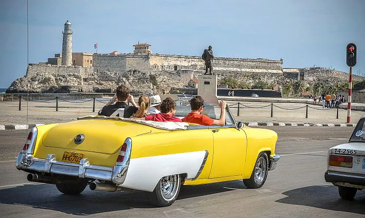  Tourists take a ride in a fully restored Mercury along the coast in Havana on March 18, 2013. Luxury is slowly reappearing in Cuban society after half a century of egalitarianism and austerity, brought upon by the economic reforms of Cuban President Raul Castro. (Adalberto Roque/AFP/Getty Images)