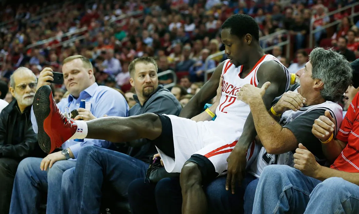 Patrick Beverly #12 of the Houston Rockets lands in the crowd after chasing a baskekball during the game against the San Antonio Spurs at Toyota Center on March 24, 2013 in Houston, Texas.  (Scott Halleran/Getty Images)
