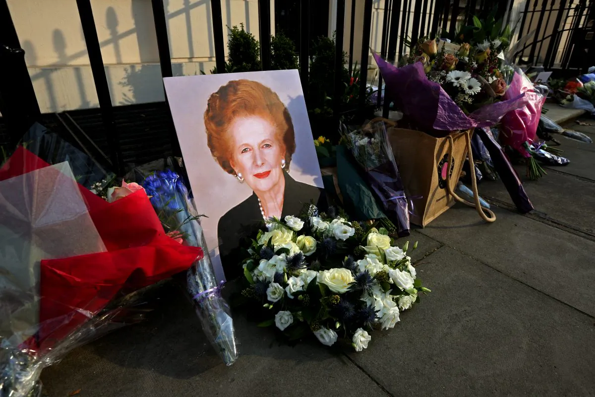 A portrait of former Prime Minister Margaret Thatcher is left next to floral tributes outside her residence in Chester Square in London, England, on April 8, 2013. (Peter Macdiarmid/Getty Images)
