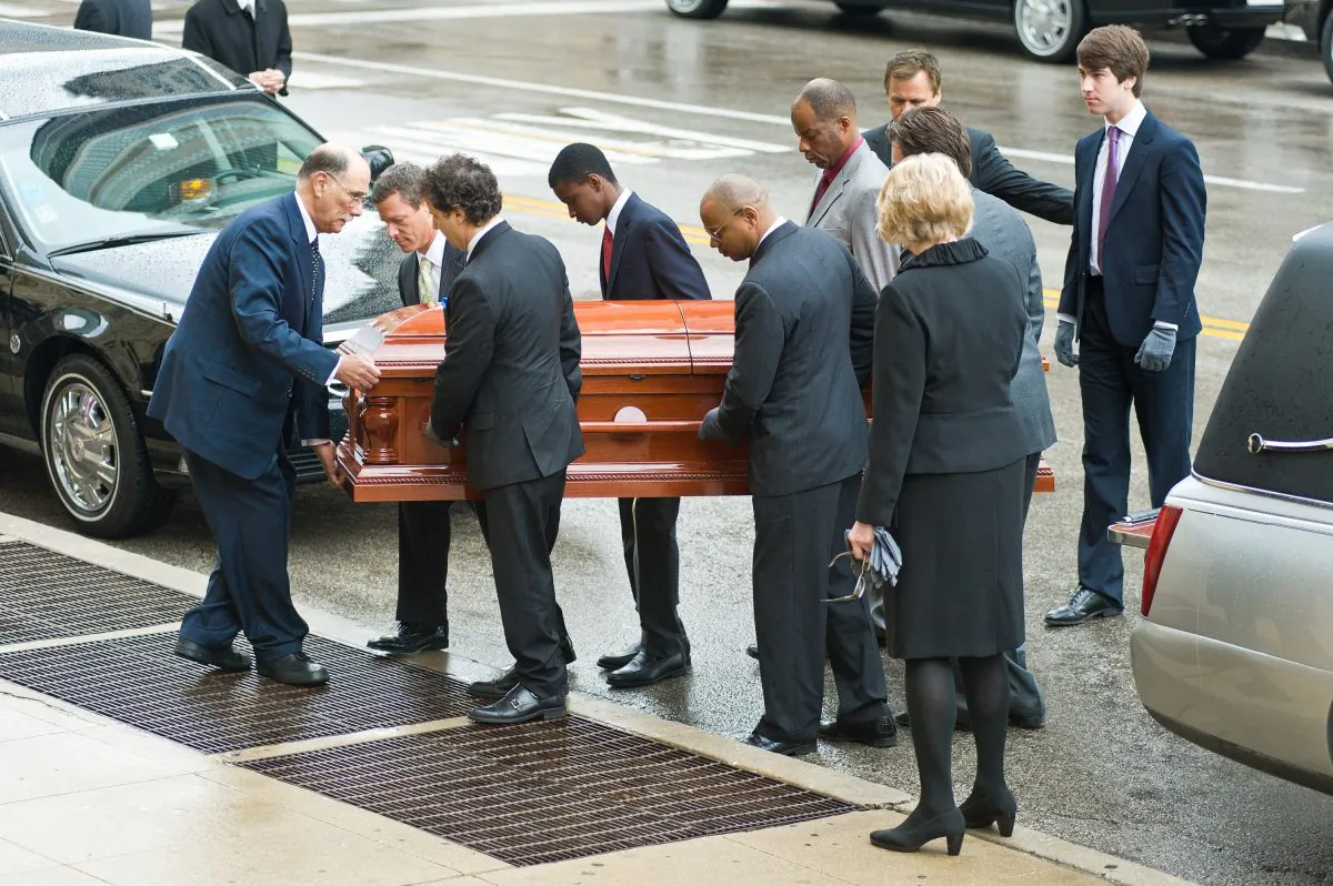 Pallbearers carry the coffin of Roger Ebert at the funeral services for Roger Ebert at Holy Name Cathedral on April 8, 2013 in Chicago, Illinois.  (Timothy Hiatt/Getty Images)