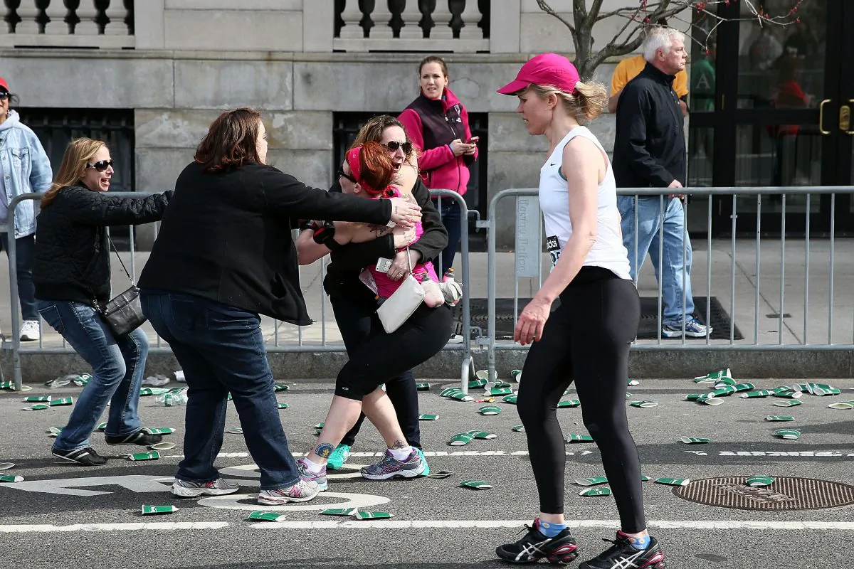 A runner embraces another woman near Kenmore Square after three bombs exploded during the 117th Boston Marathon on April 15, 2013 in Boston, Massachusetts. (Alex Trautwig/Getty Images) 